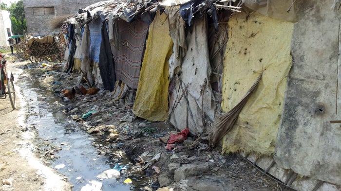 "Trench behind huts in Uttar Pradesh, India" 
