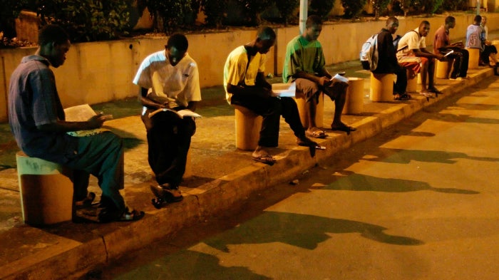 "Students in Guinea Study Under Streetlights" 